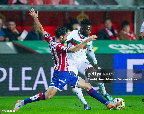 Success Ajayi Isaac of Granada CF duels for the ball with Alex Menendez of Real Sporting de Gijon during the La Liga match between Real Sporting de...