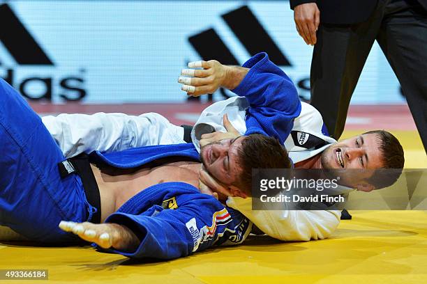 Marc Odenthal of Germany taps the mat to submit as Aleksandar Kukolj of Serbia uses a 'naked strangle' to secure the submission in their Under 90kg...