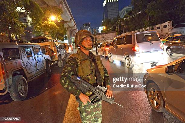 Thai army soldier looks on as rush hour traffic moves slowly along a city centre road after protesters hold an anti-coup rally on May 23, 2014 in...