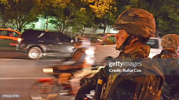 Thai army soldier looks on as rush hour traffic moves slowly along a city centre road after protesters hold an anti-coup rally on May 23, 2014 in...