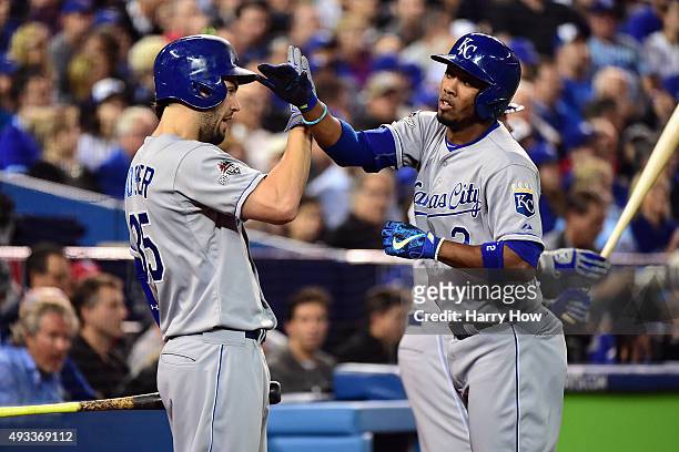 Alcides Escobar of the Kansas City Royals celebrates with Eric Hosmer of the Kansas City Royals after scoring a run in the first inning against the...