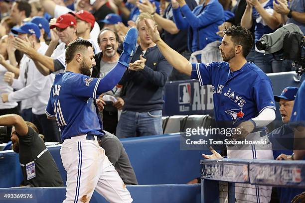 Kevin Pillar of the Toronto Blue Jays celebrates with Chris Colabello of the Toronto Blue Jays after scoring a run in the second inning against the...