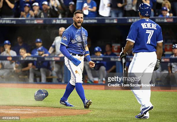 Kevin Pillar of the Toronto Blue Jays celebrates with Ben Revere of the Toronto Blue Jays after scoring a run in the second inning against the Kansas...