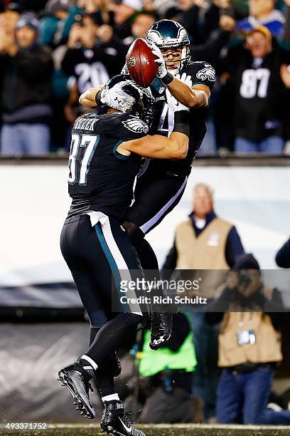 Riley Cooper of the Philadelphia Eagles is congratulated by his teammate Brent Celek after scoring a first quarter touchdown against the New York...