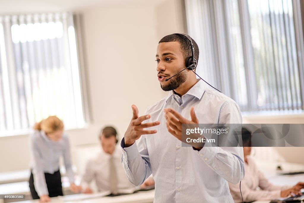 Excited salesperson talking over a bluetooth headset