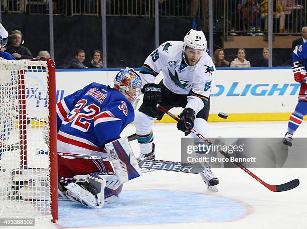 Antti Raanta of the New York Rangers makes the third period save as Barclay Goodrow of the San Jose Sharks looks for the rebound at Madison Square...