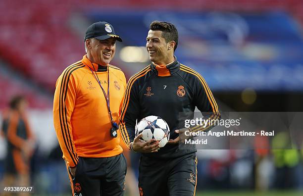 Head Coach Carlo Ancelotti of Real Madrid shares a joke with Cristiano Ronaldo during a Real Madrid training session ahead of the UEFA Champions...