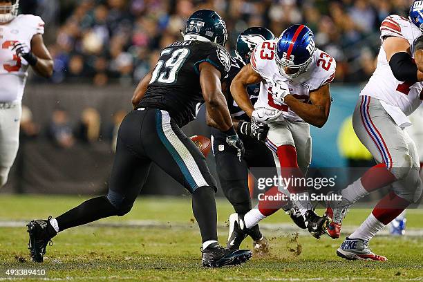 Rashad Jennings of the New York Giants fumbles the ball and is recovered by DeMeco Ryans of the Philadelphia Eagles during the second quarter at...