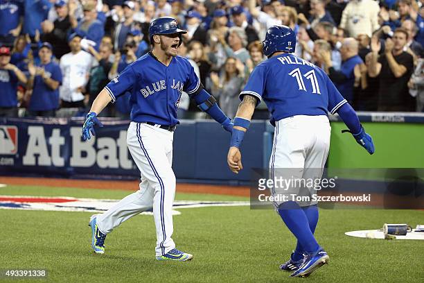 Josh Donaldson of the Toronto Blue Jays celebrates with Kevin Pillar of the Toronto Blue Jays after hitting a two-run home run in the third inning...
