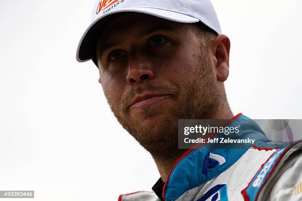 Brian Scott, driver of the Jewel-Osco/Kraft Singles Chevrolet, stands in the garage area during practice for the NASCAR Xfinity Series Furious 7 300...