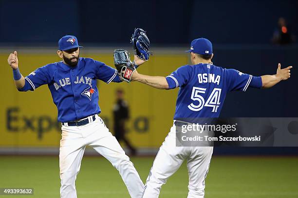 Jose Bautista of the Toronto Blue Jays celebrates with Roberto Osuna of the Toronto Blue Jays after defeating the Kansas City Royals 11-8 in game...