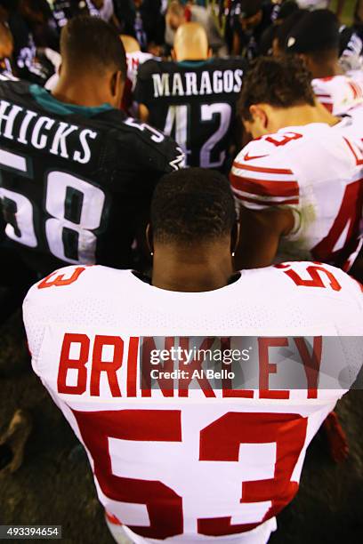 Jasper Brinkley of the New York Giants prays with the Philadelphia Eagles and New York Giants after their game at Lincoln Financial Field on October...