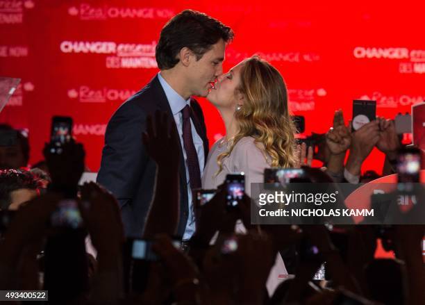 Canadian Liberal Party leader Justin Trudeau kisses his wife Sophie as they arrive on stage in Montreal on October 20, 2015 after winning the general...