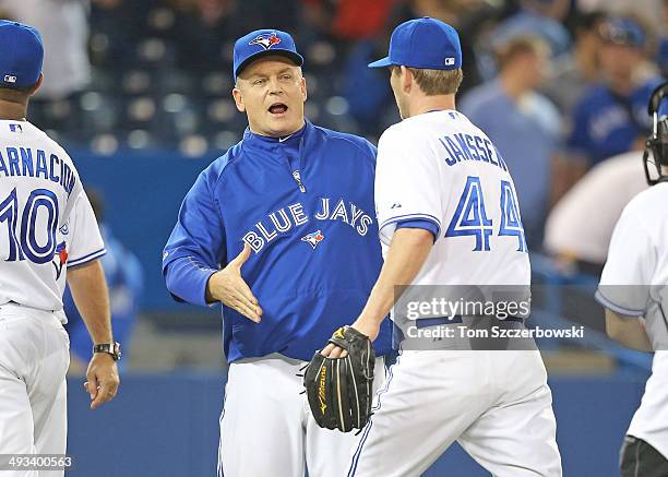 Casey Janssen of the Toronto Blue Jays is congratulated after their victory by manager John Gibbons during MLB game action against the Cleveland...