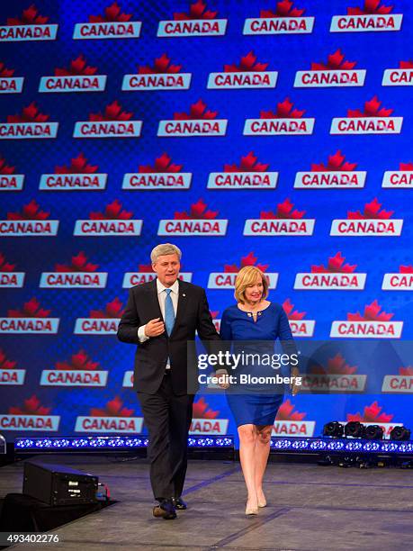 Conservative Leader Stephen Harper, Canada's prime minister, walks on stage with his wife Laureen Harper at a news conference where he conceded...