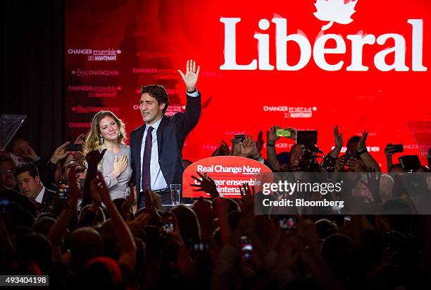 Justin Trudeau, Canada's prime minister-elect and leader of the Liberal Party of Canada, and his wife Sophie Gregoire-Trudeau wave to supporters on...