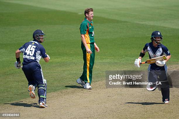 James Faulkner of Tasmania looks on as Matthew Wade and Daniel Christian of Victoria run between the wicket during the Matador BBQs One Day Cup match...