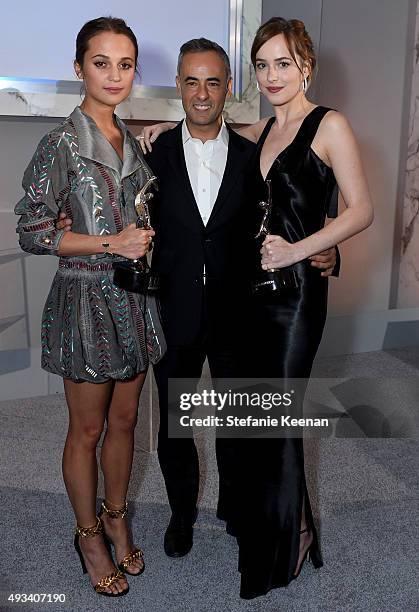 Honoree Alicia Vikander, Women's Creative Director of Calvin Klein Collection Francisco Costa and honoree Dakota Johnson pose with awards during the...