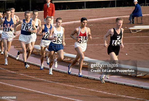Murray Halberg of New Zealand leads Mohammed Gammoudi of Tunisia, Bengt Najde of Sweden and the rest of the pack during heat 3 of the first round of...