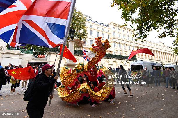 Pro-China supporters perform a dragon dance infront of supporters of Amnesty International who are protesting against claims of a deterioration in...