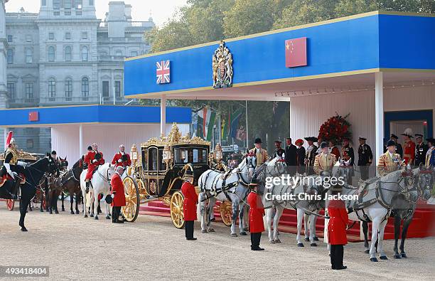 Queen Elizabeth II and Chinese President Xi Jinping board the carriage during the Official Ceremonial Welcome for the Chinese State Visit on October...