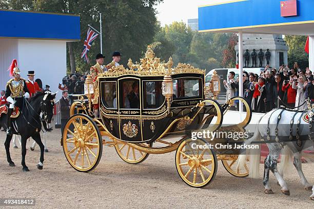 Queen Elizabeth II and Chinese President Xi Jinping board the carriage during the Official Ceremonial Welcome for the Chinese State Visit on October...