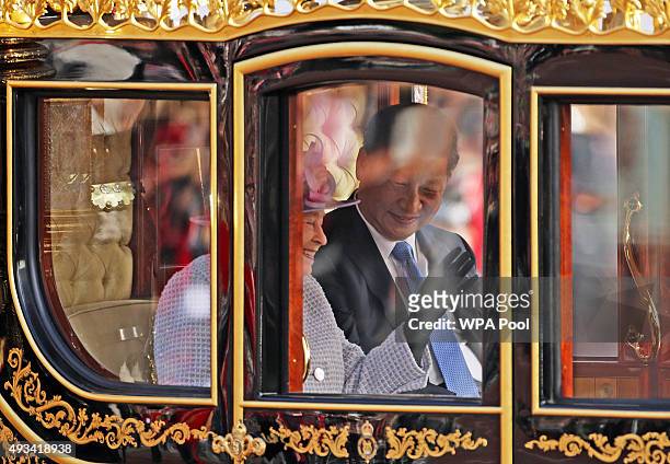 Queen Elizabeth II and President of The People's Republic of China, Xi Jinping, ride in the Diamond Jubilee State Coach along The Mall after the...