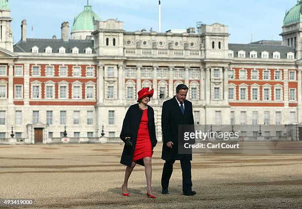 Prime Minister David Cameron talks with Home Secretary Theresa May after greeting China's President, Xi Jinping, at an honour guard on October 20,...
