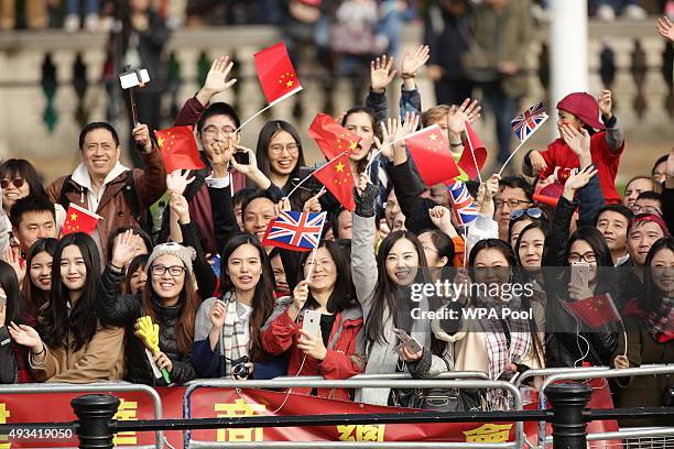 Spectators wait for Queen Elizabeth II and President of The People's Republic of China, Mr Xi Jinping, to pass along The Mall after the ceremonial...