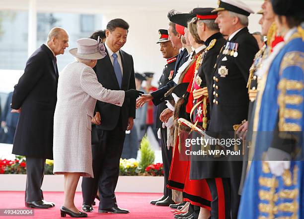 Queen Elizabeth II, introduces the Chinese President Xi Jinping, 3rd left, to Britain's Prime Minister David Cameron, during the official welcome...