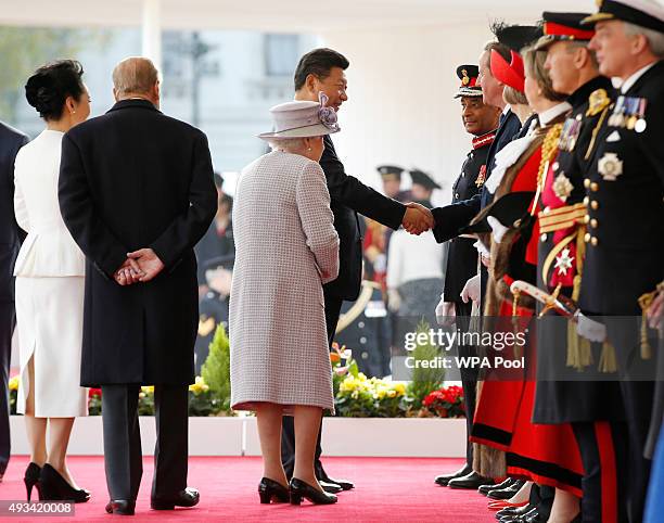 Queen Elizabeth II introduces the Chinese President Xi Jinping to Britain's Prime Minister David Cameron, during the official welcome ceremony at...