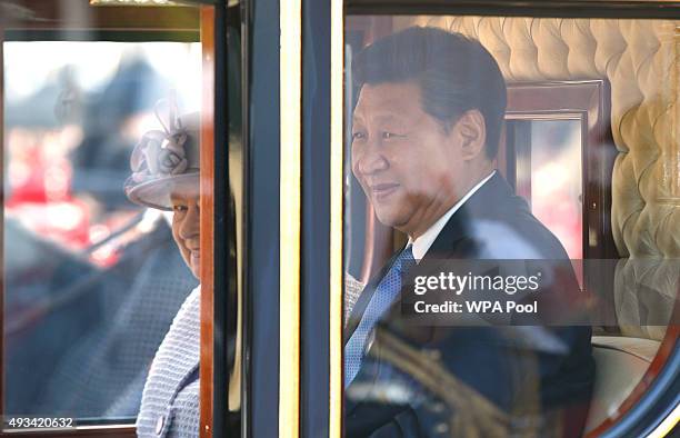 Queen Elizabeth II sits with the Chinese President Xi Jinping in the Diamond Jubilee State Coach following the official welcome ceremony at Horse...