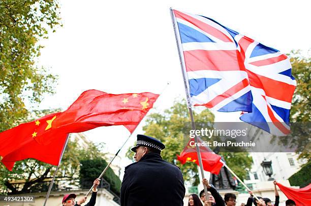 Policeman seperates the Pro-China supporters and supporters of Amnesty International who are protesting against claims of a deterioration in human...