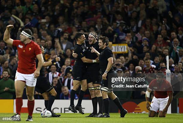 Brodie Retallick of the New Zealand All Blacks celebrates scoring a try with Dan Carter and Richie McCaw of the New Zealand All Blacks during the...