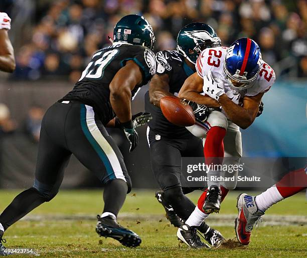 Rashad Jennings of the New York Giants fumbles the ball as Malcolm Jenkins of the Philadelphia Eagles hits him and it is recovered by DeMeco Ryans...