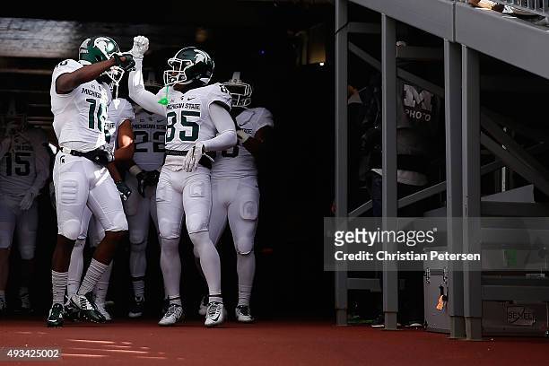 Wide receivers Aaron Burbridge and Macgarrett Kings Jr. #85 of the Michigan State Spartans take the field before the college football game against...