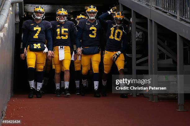 Quarterbacks Shane Morris, Jake Rudock, Wilton Speight and Zach Gentry of the Michigan Wolverines of the Michigan Wolverines take the field for warm...