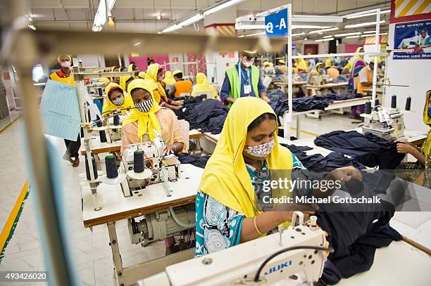 Gazipur, Bangladesh A female worker at a sewing machine in the production facility of GBL Group textile manufacurer on October 07, 2015 in Gazipur,...