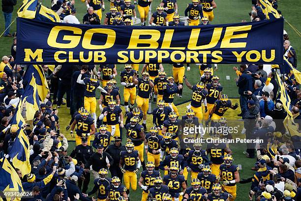 The Michigan Wolverines take the field before the college football game against the Michigan State Spartans at Michigan Stadium on October 17, 2015...