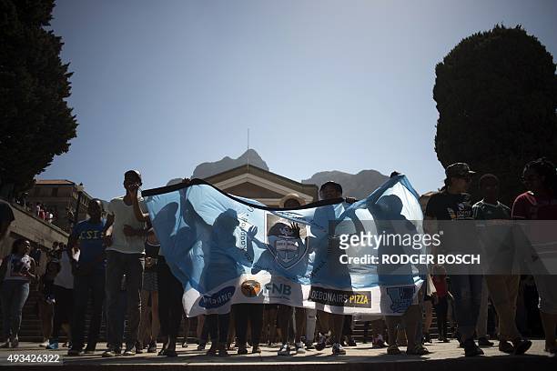 Students hold banner during a protest against fee hikes at the University of Cape Town on October 20, 2015. Student protests halted teaching at three...