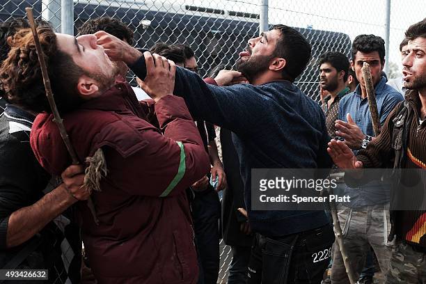 Afghan men with sticks fight with other recently arrived migrants waiting to be processed at the increasingly overwhelmed Moria camp on the island of...