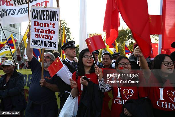 Pro-China and Tibetan independence activists demonstrate near Parliament ahead of a visit by China's President, Xi Jinping on October 20, 2015 in...