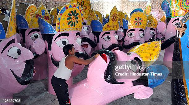 Final touches are being given by artists to the effigies of the mythical demon King Ravana for the upcoming Dussehra festival on October 20, 2015 in...