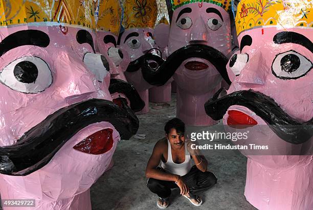 Artist taking rest after giving final touches to the effigies of the mythical demon King Ravana for the upcoming Dussehra festival on October 20,...