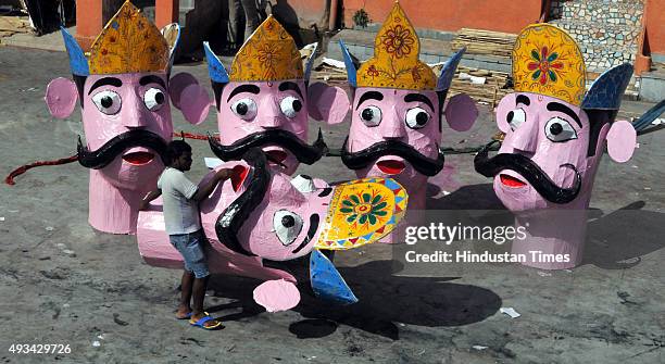 Final touches are being given by artists to the effigies of the mythical demon King Ravana for the upcoming Dussehra festival on October 20, 2015 in...