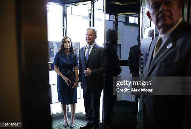 Former U.S. Sen. Jim Webb and his wife Hong Le Webb leave after a news conference at the National Press Club October 20, 2015 in Washington, DC. Sen....