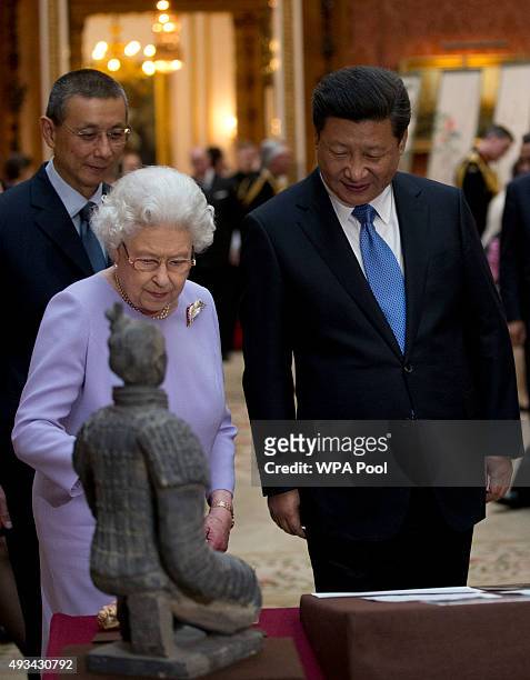 Chinese President Xi Jinping with Britain's Queen Elizabeth II view a display of Chinese items from the Royal Collection at Buckingham Palace on...