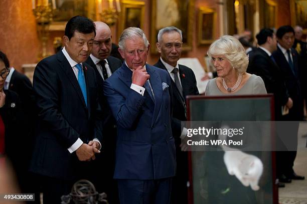 Britain's Prince Charles, Prince of Wales , Camilla, Duchess of Cornwall and Chinese ambassador to the UK Liu Xiaoming view a display of Chinese...