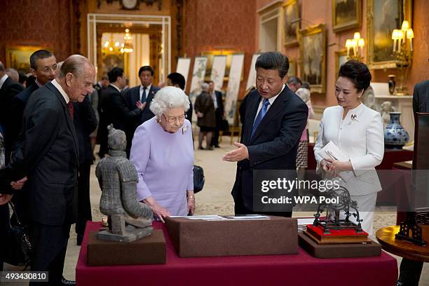 Chinese President Xi Jinping and China's First Lady Peng Liyuan with Britain's Queen Elizabeth II and Prince Philip, Duke of Edinburgh view a display...