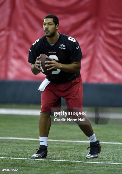 Logan Thomas of the Arizona Cardinals gets ready to drop back to pass during a Rookie Minicamp practice on May 23, 2014 in Tempe, Arizona.